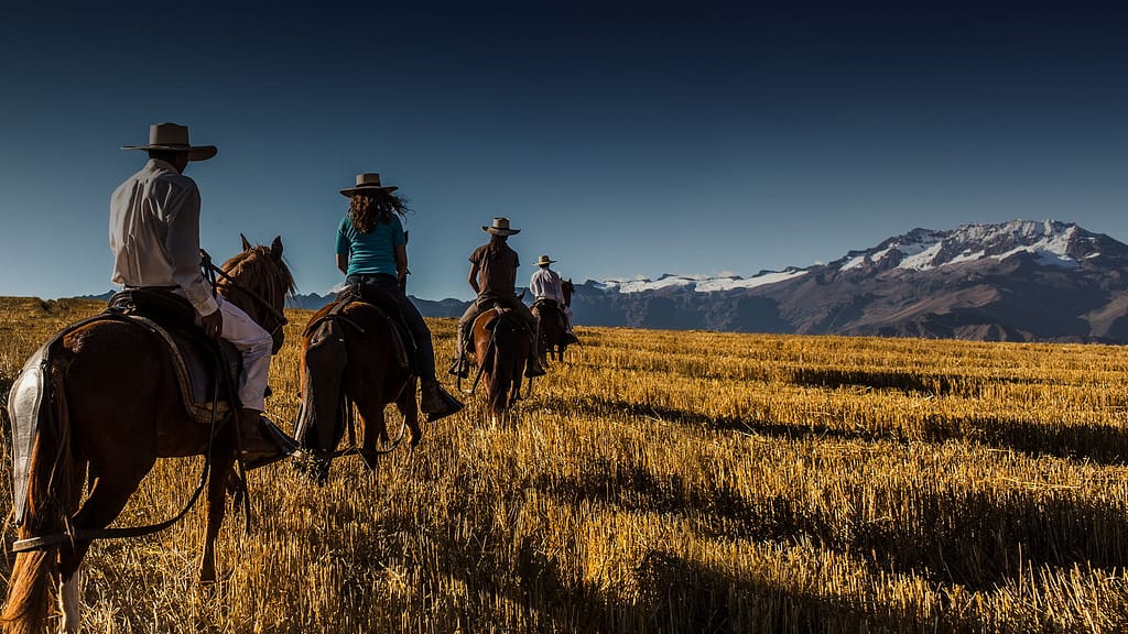 Things to do in Sacred Valley - Horseback riding past snow-capped mountains.