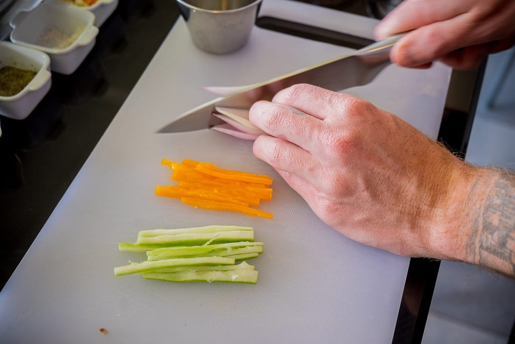 Cooking class in Cusco - Chopping vegetables for ceviche.